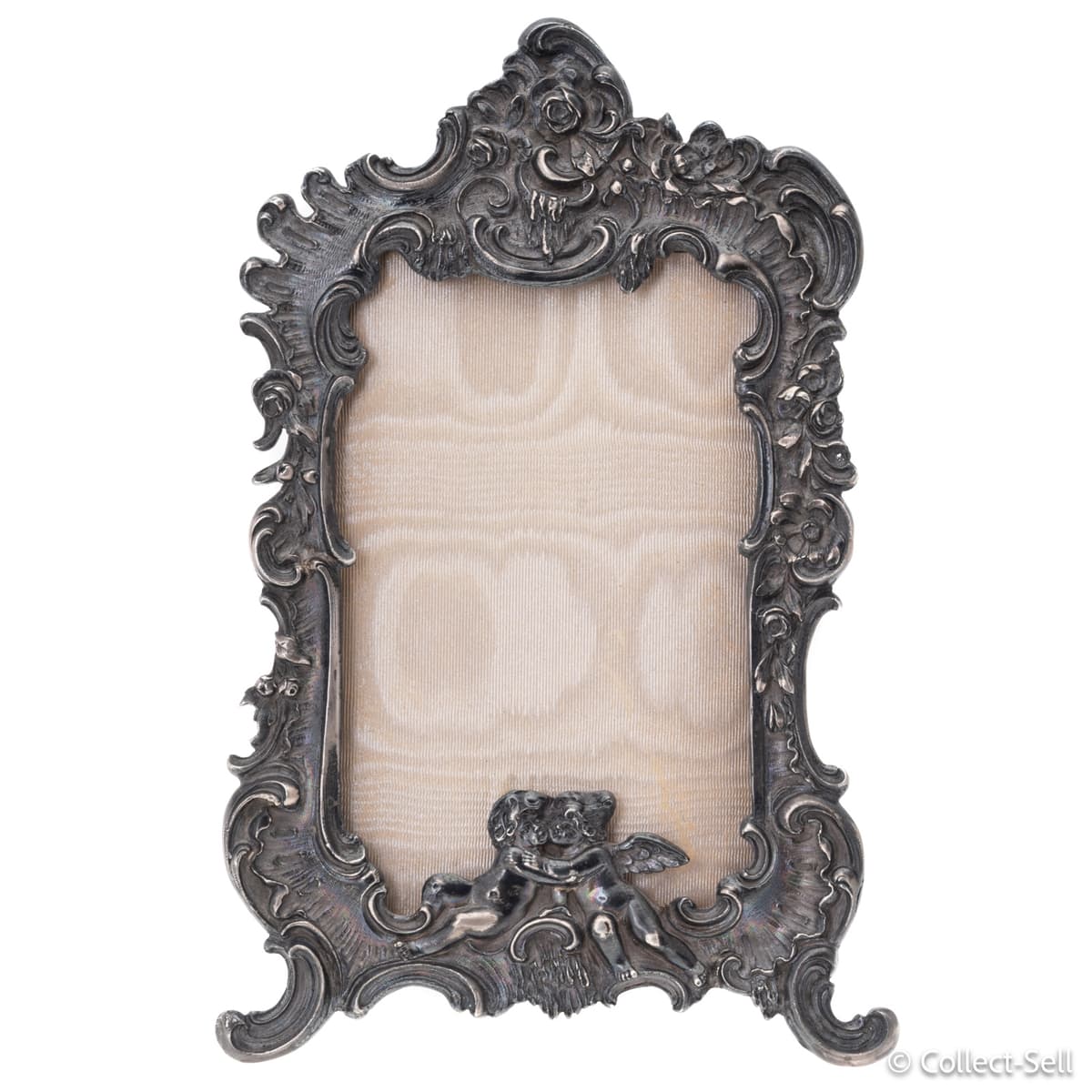 Front view of ornate antique German sterling silver picture frame with cherub